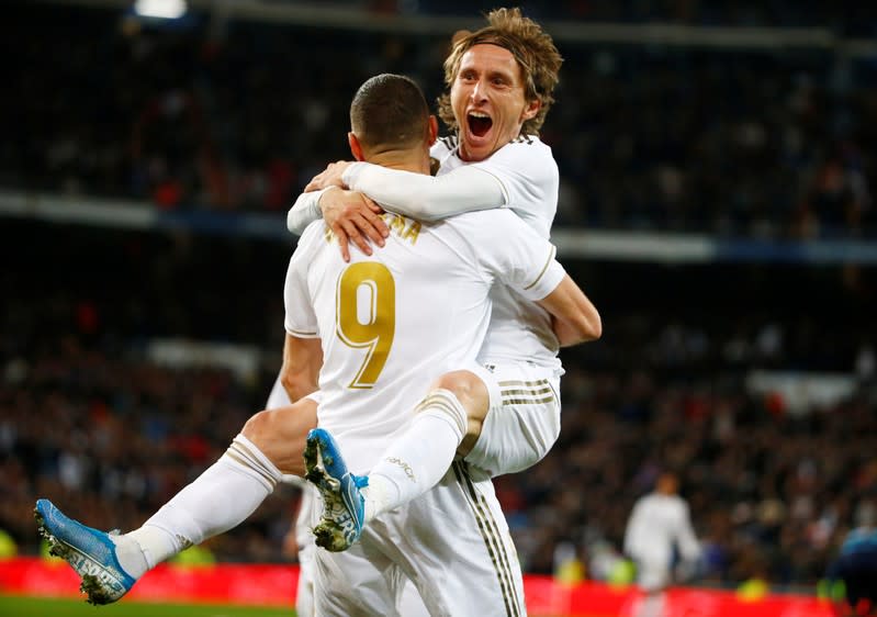 Luka Modric del Real Madrid celebra el tercer gol contra la Real Sociedad, con Karim Benzema.