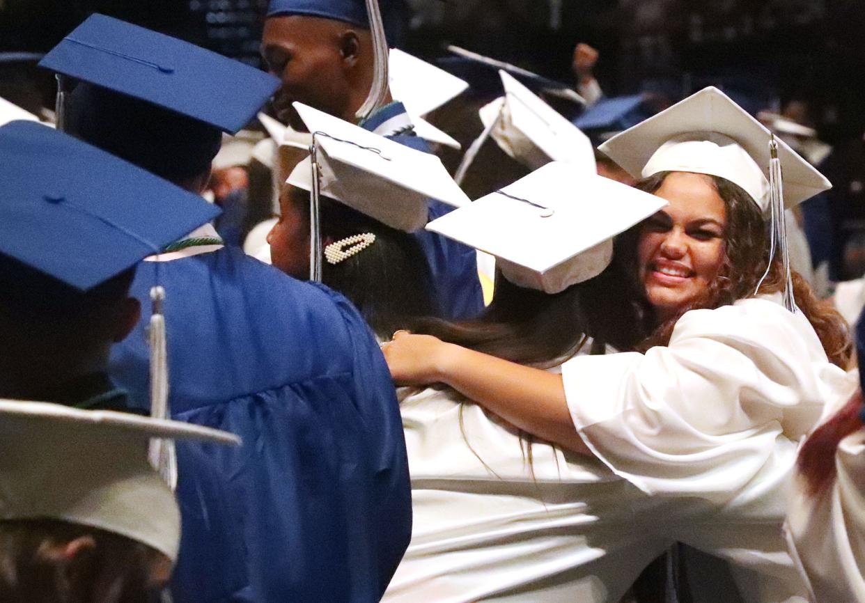 Cheering Deltona High School graduates hug after moving their tassels to the other side of their caps, Wednesday May 25, 2022 at the end of their commencement exercise at the Ocean Center.
