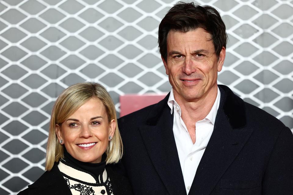 Mercedes team principal Toto Wolff (R) and his wife Swiss pilot Susie Wolff pose on the red carpet upon arrival for the UK premier of 