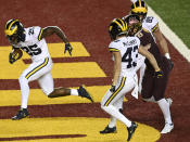 Michigan running back Hassan Haskins (25) runs for a touchdown in the first half of an NCAA college football game against Minnesota Saturday, Oct. 24, 2020, in Minneapolis, Minn. (Aaron Lavinsky/Star Tribune via AP)