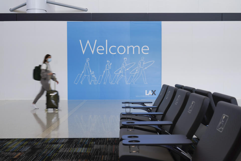 A passenger walks through the new West Gates at Tom Bradley International Terminal at Los Angeles International Airport Monday, May 24, 2021, in Los Angeles. (AP Photo/Ashley Landis)