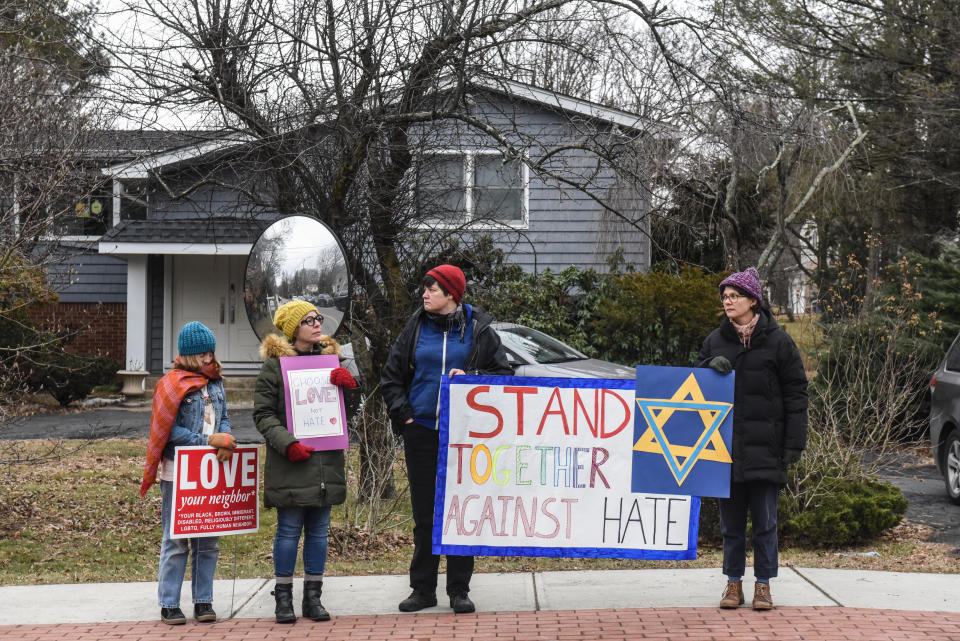 People hold signs of support near the house of Rabbi Chaim Rottenberg on December 29, 2019 in Monsey, New York., where five people were injured in a knife attack during a Hanukkah party. (Photo: Stephanie Keith/Getty Images)