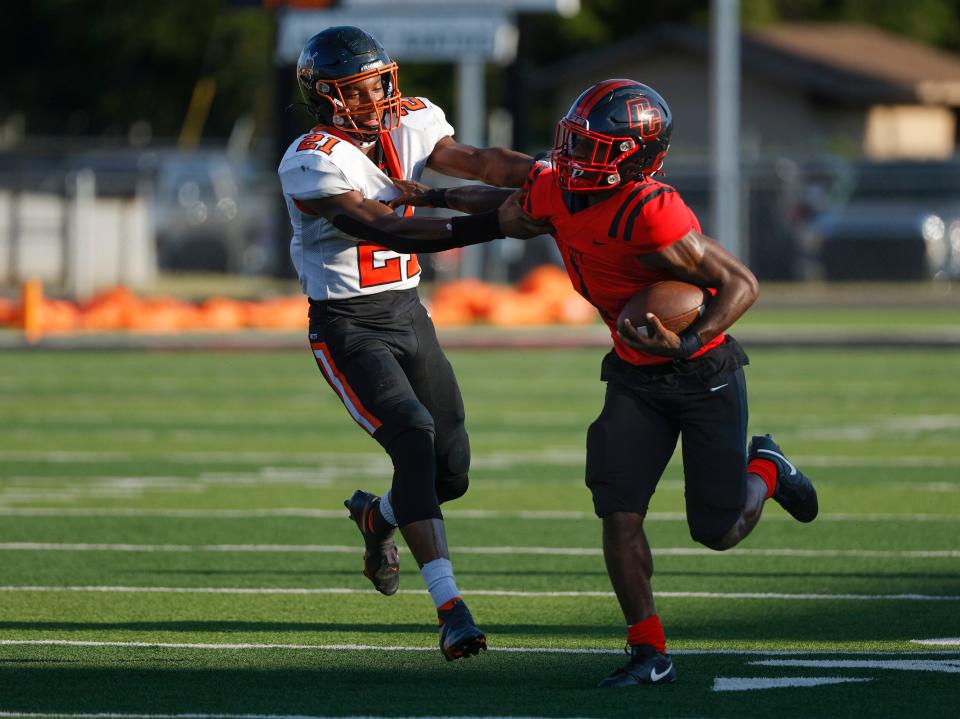Del City's Rodney Fields tries to get by Booker T. Washington's Yiramiyah Parry during the high school football game between Del City and Booker T. Washington at Del City High School in Del City, Okla., Thursday, Aug., 31, 2023.