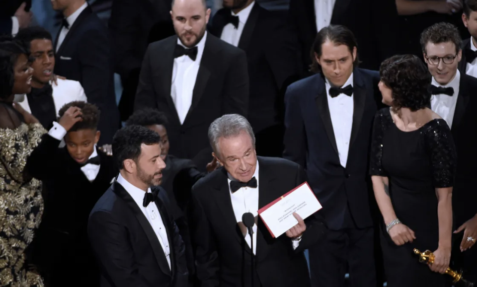 Warren Beatty holding an envelope