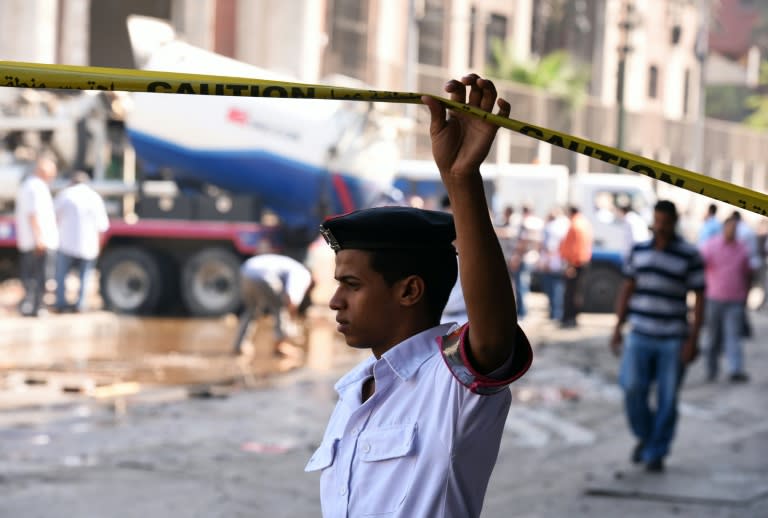 An Egyptian policeman cordons off the site of a powerful bomb explosion that ripped through the Italian consulate in Cairo, on July 11, 2015