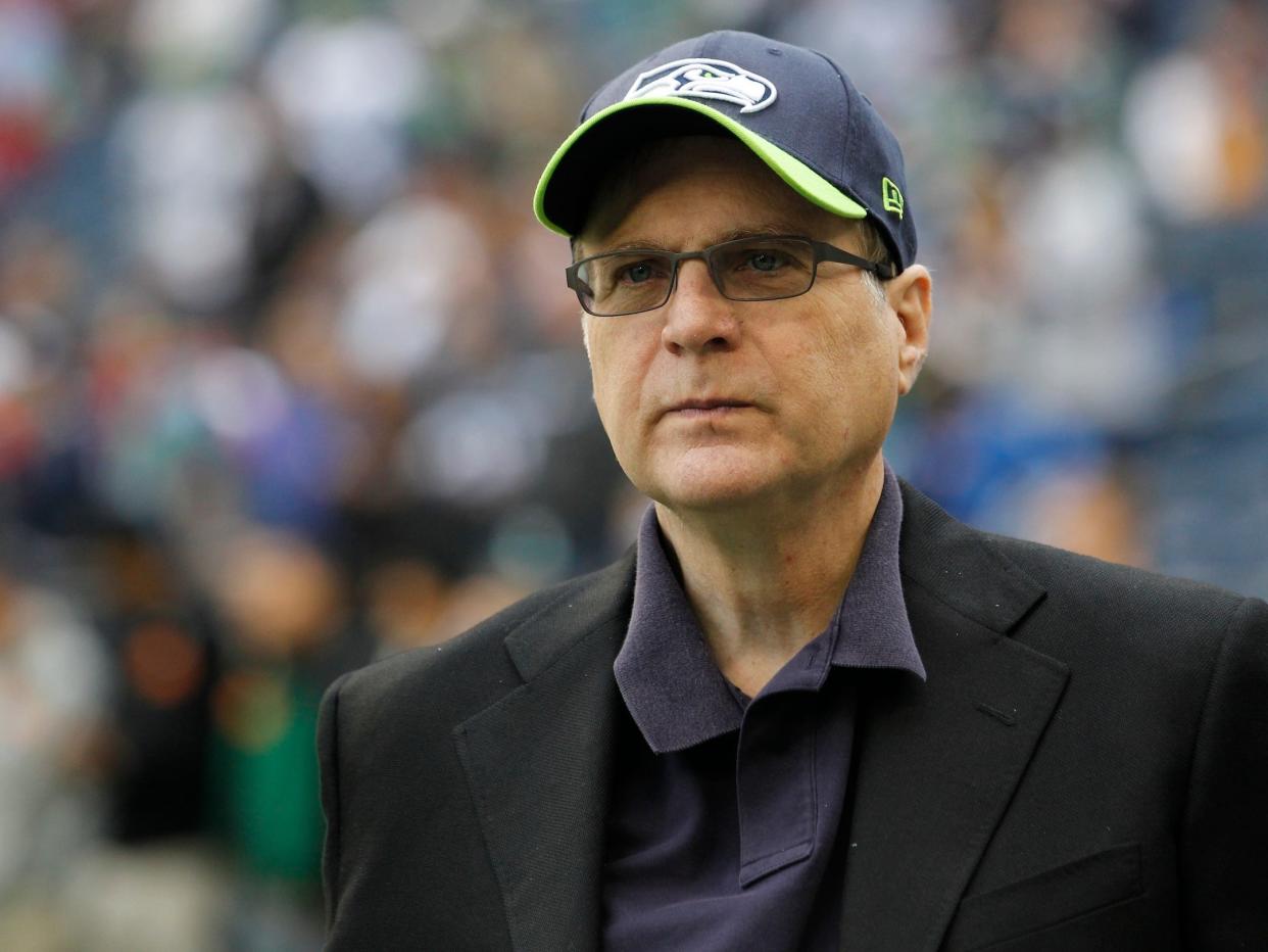 Paul Allen, Microsoft's cofounder, wearing Seattle Seahawks hat while standing in stadium