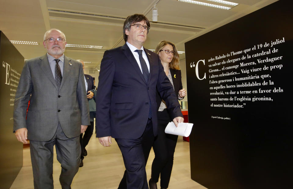 Former Catalan leader Carles Puigdemont, center, arrives for a media conference in Brussels, Monday, Oct. 14, 2019. Spain's Supreme Court has convicted 12 former Catalan politicians and activists for their roles in the secession movement of 2017. (AP Photo/Olivier Matthys)