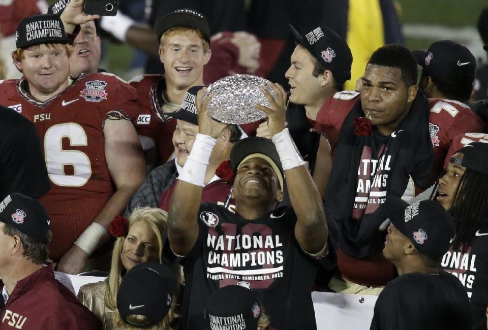 Florida State&#39;s Jameis Winston celebrates with The Coaches&#39; Trophy after the NCAA BCS National Championship college football game against Auburn Monday, Jan. 6, 2014, in Pasadena, Calif. Florida State won 34-31. (AP Photo/Gregory Bull)