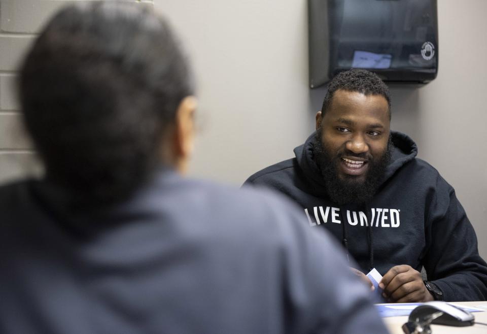 Jeff Rozier, who was site coordinator with United Way of Erie County, talks with Savannah Wilson, during an Erie Free Taxes session at the Booker T. Washington Center, in this Feb. 21, 2019 file photo.