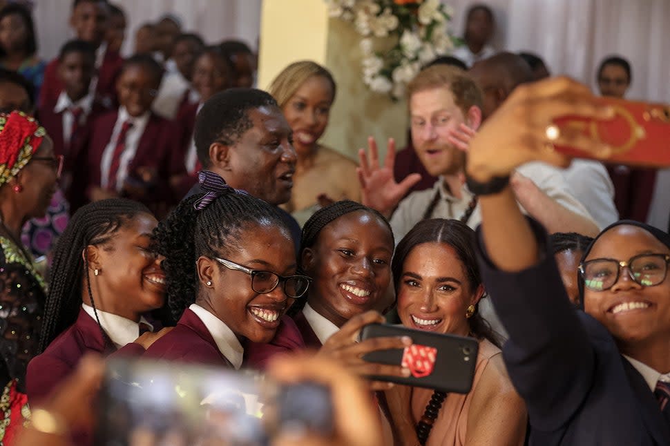 Meghan Markle takes a selfie with students during her visit at the Lightway Academy in Abuja on May 10, 2024.