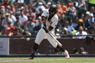 San Francisco Giants' Brandon Crawford hits an RBI-single against the Houston Astros during the sixth inning of a baseball game in San Francisco, Saturday, July 31, 2021. (AP Photo/Jed Jacobsohn)