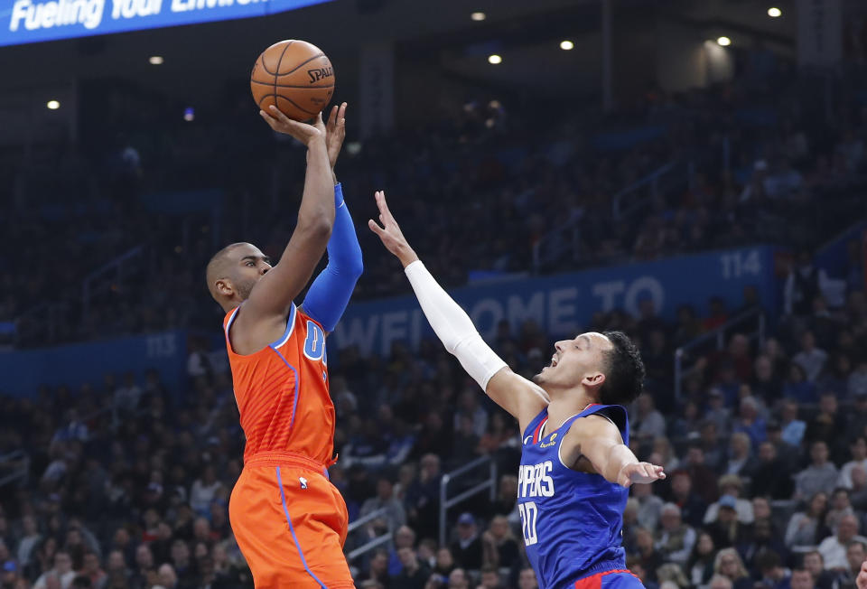 Oklahoma City Thunder guard Chris Paul, left, shoots as Los Angeles Clippers guard Landry Shamet (20) defends during the second quarter of an NBA basketball game Sunday, Dec. 22, 2019, in Oklahoma City. (AP Photo/Alonzo Adams)