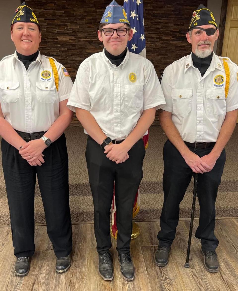 Richard Bierle (far right) and his wife Kristen (left) are members of American Legion Post 46 who joined the Custer Veteran Honor Guard. Their son, Brandon (center), a Custer High School senior, has served as a flag bearer in the color guard and will soon be trained as a member of the firing squad.