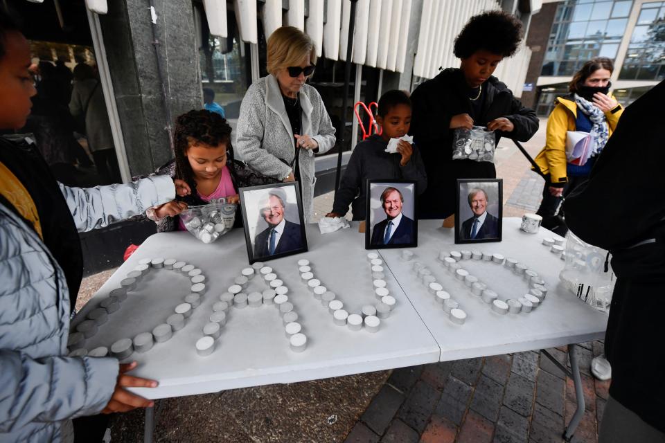 Residents set up a display of candles at the vigil in Southend (REUTERS)