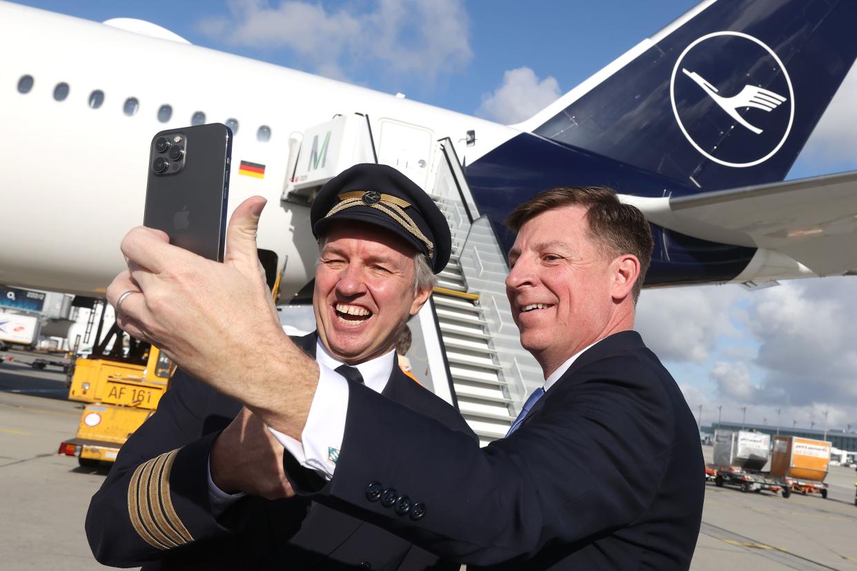 FREISING, GERMANY - NOVEMBER 08: Timothy Liston, US Consul General in Munich smiles with Lufthansa Capatin Thomas Jahn next to his Airbus A 350-900 prior to a Lufthansa flight bound non-stop for Miami at Munich Airport on the first day that U.S. authorities were allowing tourists from Europe to enter the U.S. on November 08, 2021 in Freising, Germany. (Photo by Alexander Hassenstein/Getty Images)