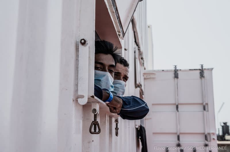Migrants wait to disembark "Ocean Viking" ship, in Augusta
