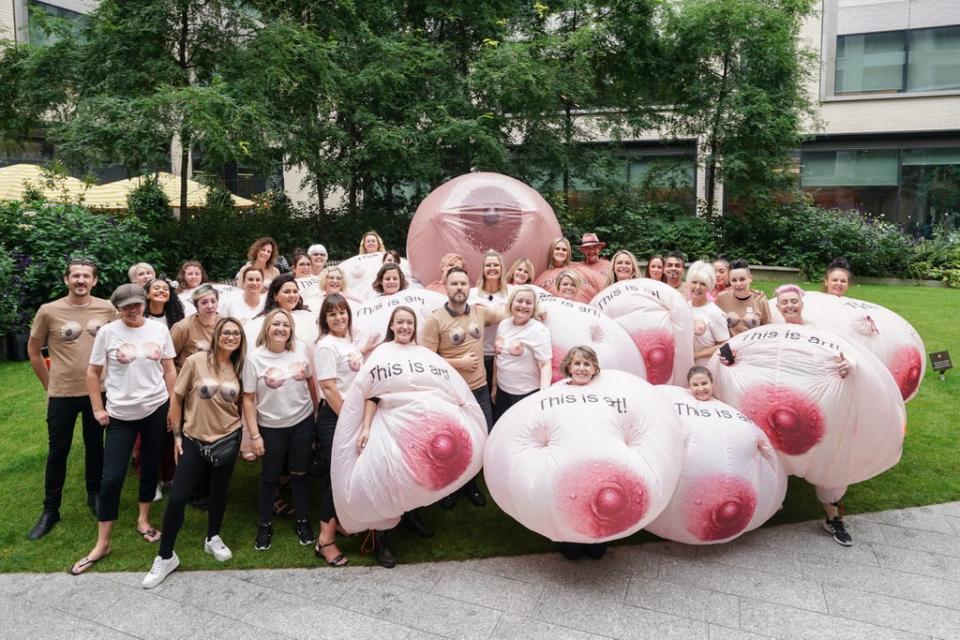 Protesters wearing inflatable breasts stand outside Facebook's headquarters in central London (PA)