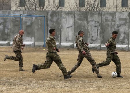 German and British troops participate in a football match to commemorate the Christmas Truce of 1914, at the ISAF Headquarters in Kabul December 24, 2014. REUTERS/Omar Sobhani