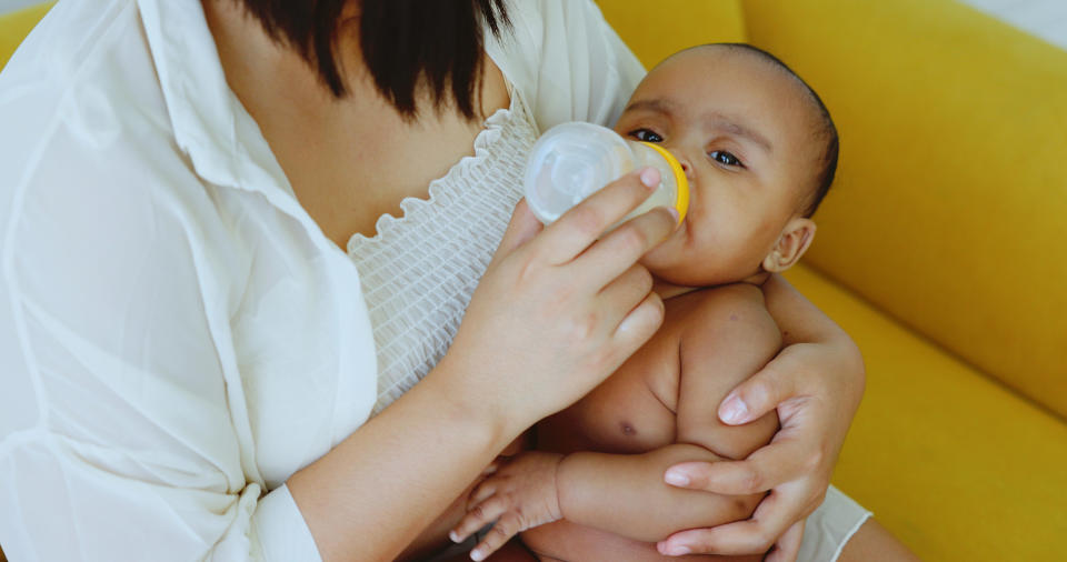 baby drinking out of a bottle