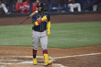 Atlanta Braves' Ronald Acuna Jr. tosses his bat after he walked during the fifth inning of the team's baseball game against the Miami Marlins, Saturday May 21, 2022, in Miami. (AP Photo/Gaston De Cardenas)