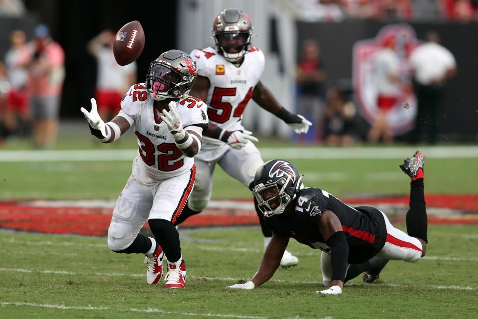 Tampa Bay Buccaneers safety Mike Edwards (32) intercepts a pass by Atlanta Falcons quarterback Matt Ryan and returns it for a score in 2021. He played for Winton Woods in the Skyline Chili Crosstown Showdown and was a star at the University of Kentucky.