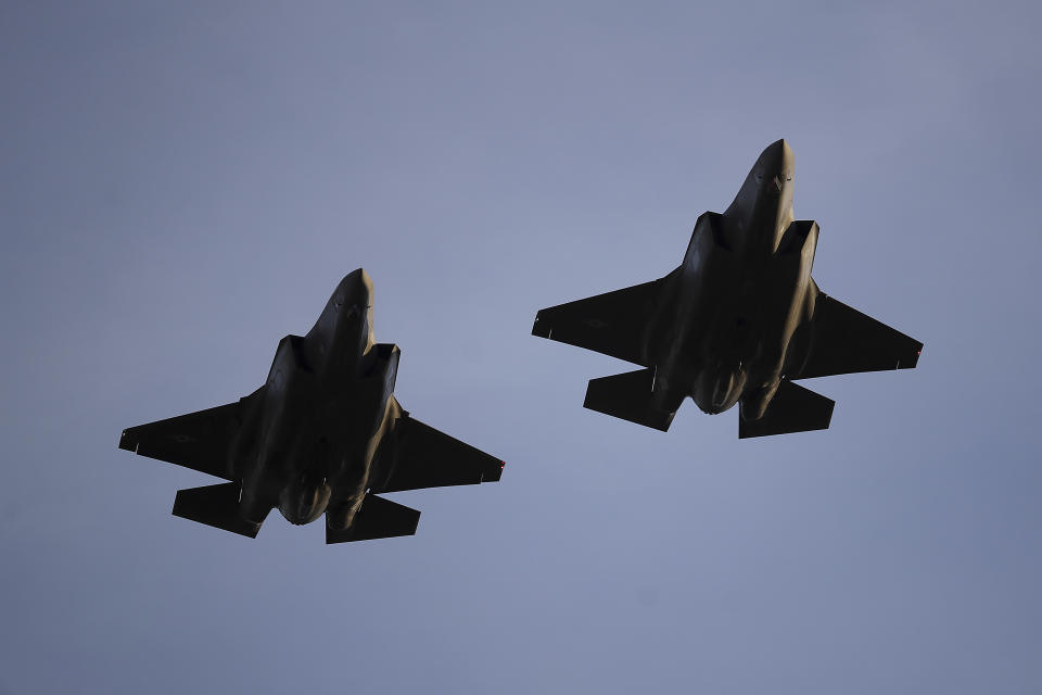 FILE - In this Nov. 1, 2018, file photo U.S. Air Force F-35 A-fighter jets from 31st Test Evaluation Squadron at Edwards AFB fly over Levi's Stadium before an NFL football game between the San Francisco 49ers and the Oakland Raiders in Santa Clara, Calif. Raytheon Co. and United Technologies Corp. are merging in a deal that creates one of the world's largest defense companies. The merger was announced Sunday, June 9, 2019. United Technologies makes engines for Lockheed Marti Corp.'s F-35 stealth fighter. (AP Photo/Ben Margot, File)