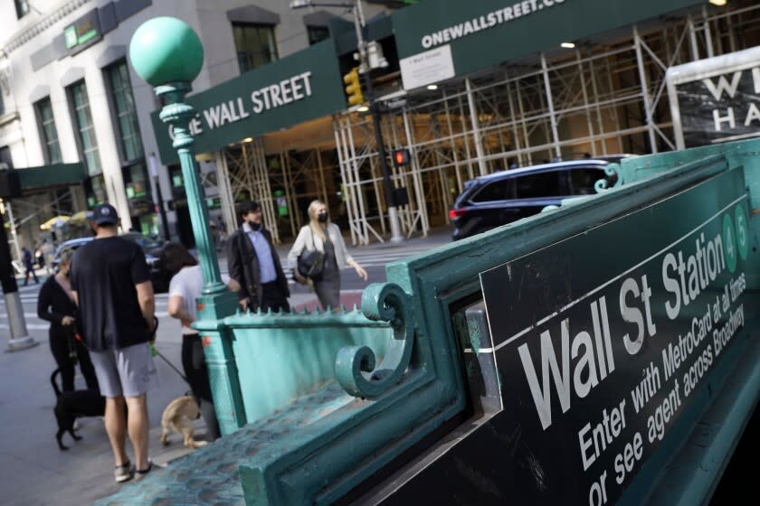 FILE - People walk on Broadway at Wall Street, Wednesday, June 16, 2021. Stocks are opening lower on Wall Street, Wednesday, May 18, 2022, led by steep drops in retailers as Target plunged after issuing a grim quarterly earnings report.AP Photo/Richard Drew, File)