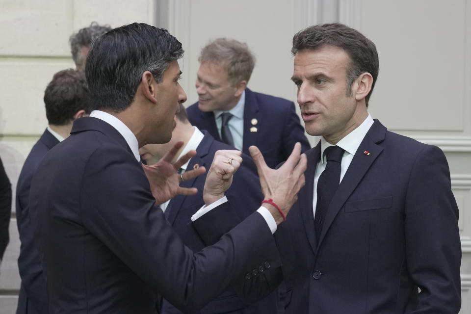 French President Emmanuel Macron, right, and Britain's Prime Minister Rishi Sunak talk after a group picture with ministers during a French-British summit at the Elysee Palace in Paris, Friday, March 10, 2023. French President Emmanuel Macron and British Prime Minister Rishi Sunak meet for a summit aimed at mending relations following post-Brexit tensions, as well as improving military and business ties and toughening efforts against Channel migrant crossings. (AP Photo/Kin Cheung, Pool)