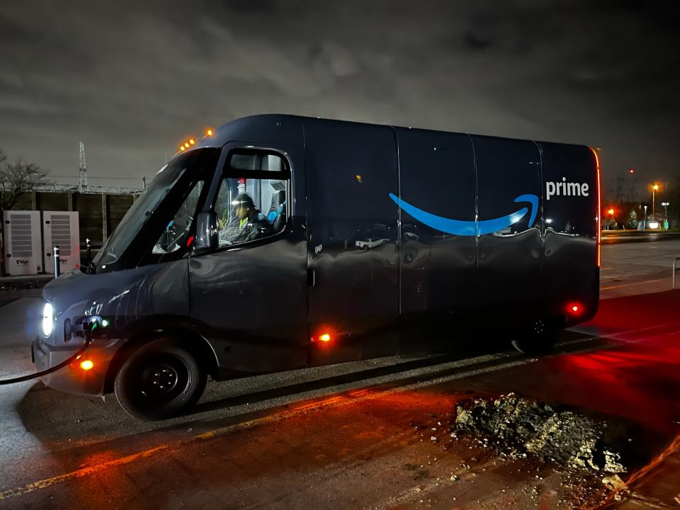 Rivian-built Amazon electric delivery vehicle stopped for charging during testing on Detroit-area roads.