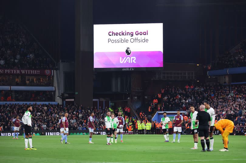 Liverpool and Aston Villa players wait for VAR to decide on an Ollie Watkins goal during the clash at Villa Park