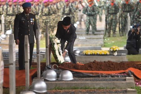 Indonesia's President Joko Widodo lays a wreath of flowers during funeral ceremony of former Indonesian President B.J. Habibie, who passed away yesterday, at Kalibata Heroes cemetery complex in Jakarta