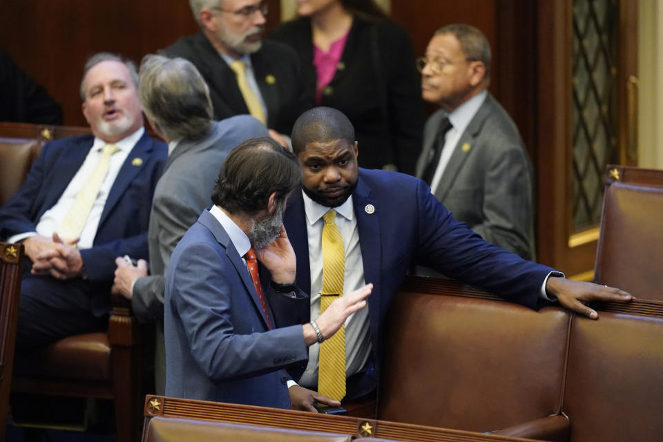 Rep. Byron Donalds, R-Fla., talks with colleagues in the House chamber after six failed votes to elect a new speaker, and a motion to adjourn for the day, in Washington, Wednesday, Jan. 4, 2023. (AP Photo/Alex Brandon)