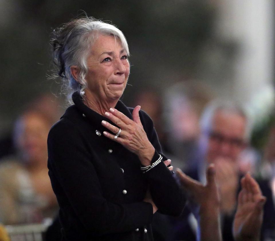 Jeannie Flossie becomes emotional as attendees applaud her late husband, Tim, during the 2023 Akron Public Schools Athletics Hall of Fame induction ceremony Saturday at House Three Thirty in Akron.