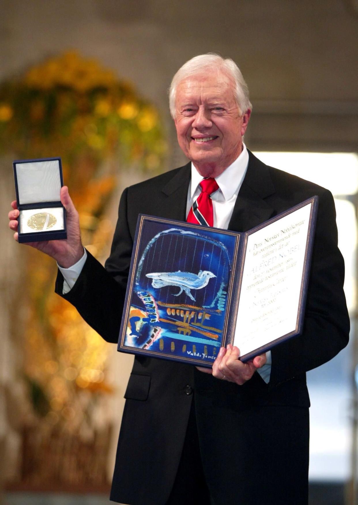 Former President Jimmy Carter smiles after receiving the 2002 Nobel Peace Prize during a ceremony in the Oslo City Hall on Dec. 10, 2002, in Oslo, Norway.