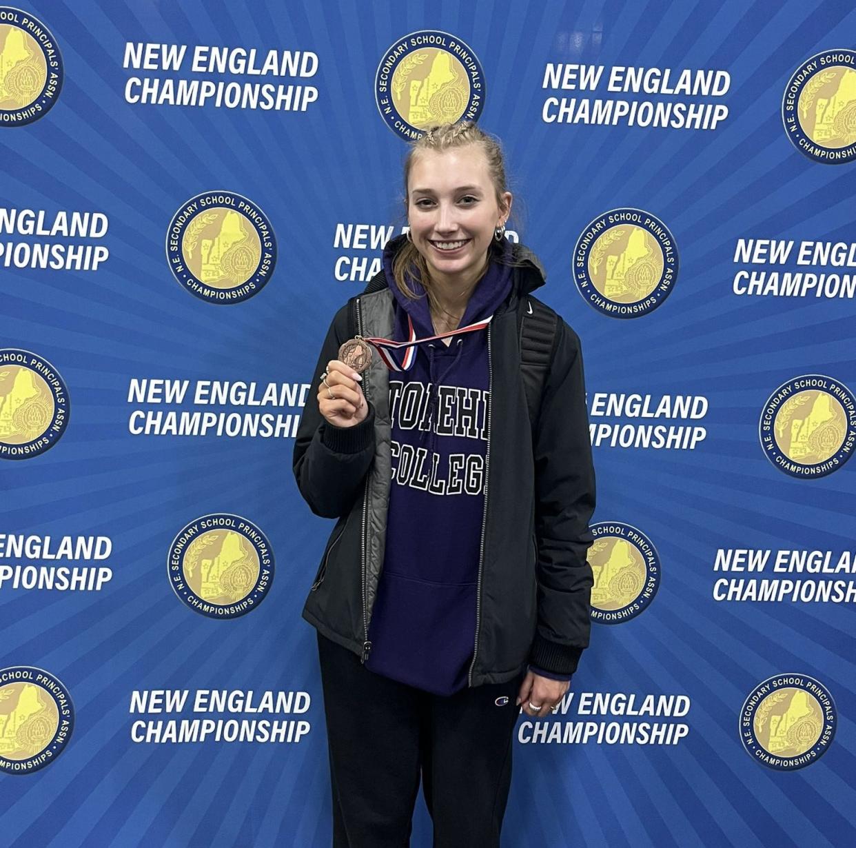 Case winter track and field athlete Hannah Santos shows her medal after competing in New England.