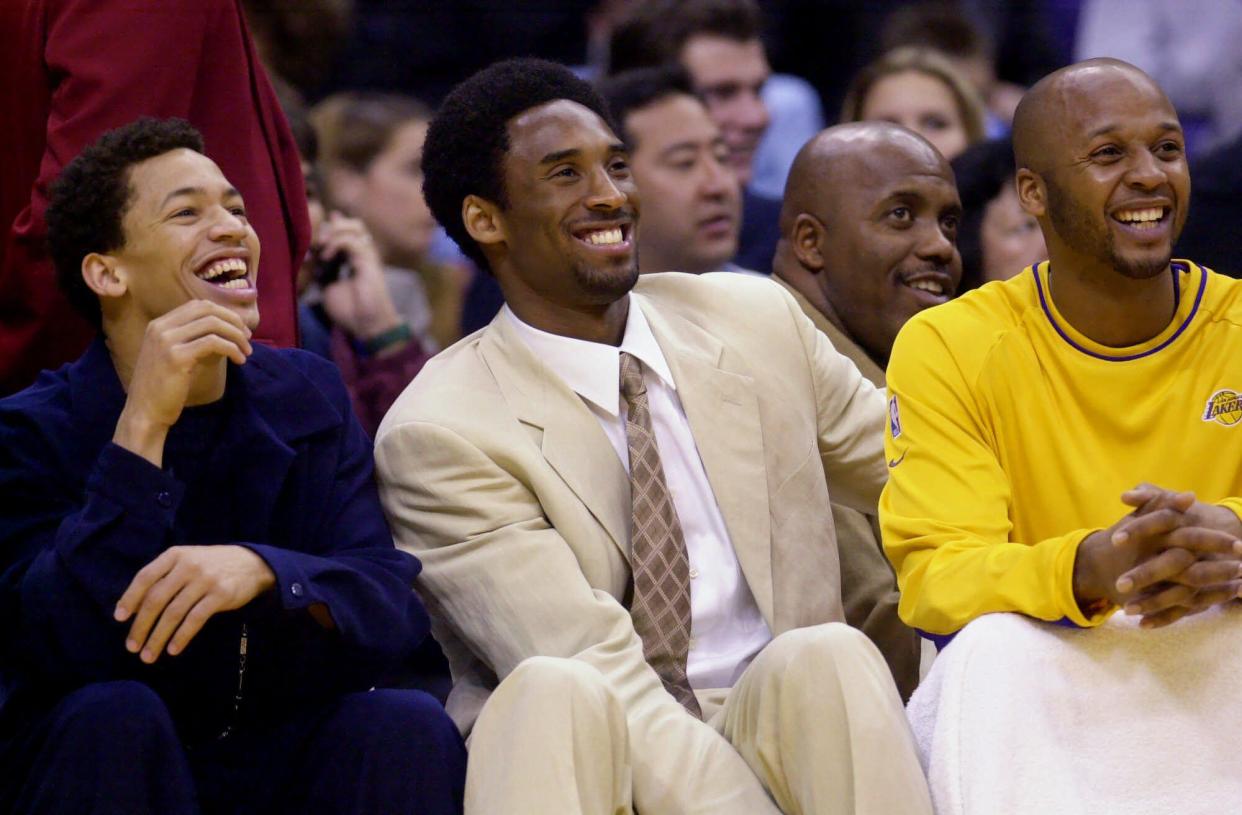 Los Angeles Lakers' Tyronn Lue, left, Kobe Bryant, center, and Brian Shaw are all smiles as they watch their teammates play the Washington Wizards in the second quarter Friday, March 23, 2001, in Los Angeles.