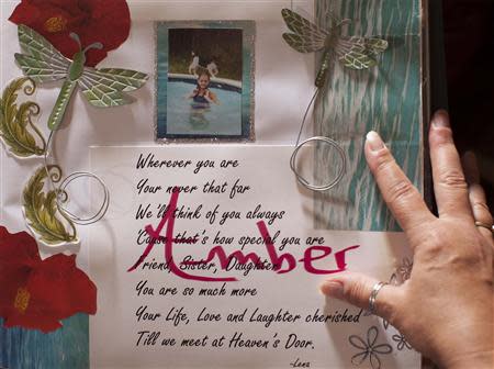 Terry DiBattista looks over an album created in memory of her adopted daughter Amber Rose at her home in Conway, South Carolina March 28, 2014. REUTERS/Randall Hill