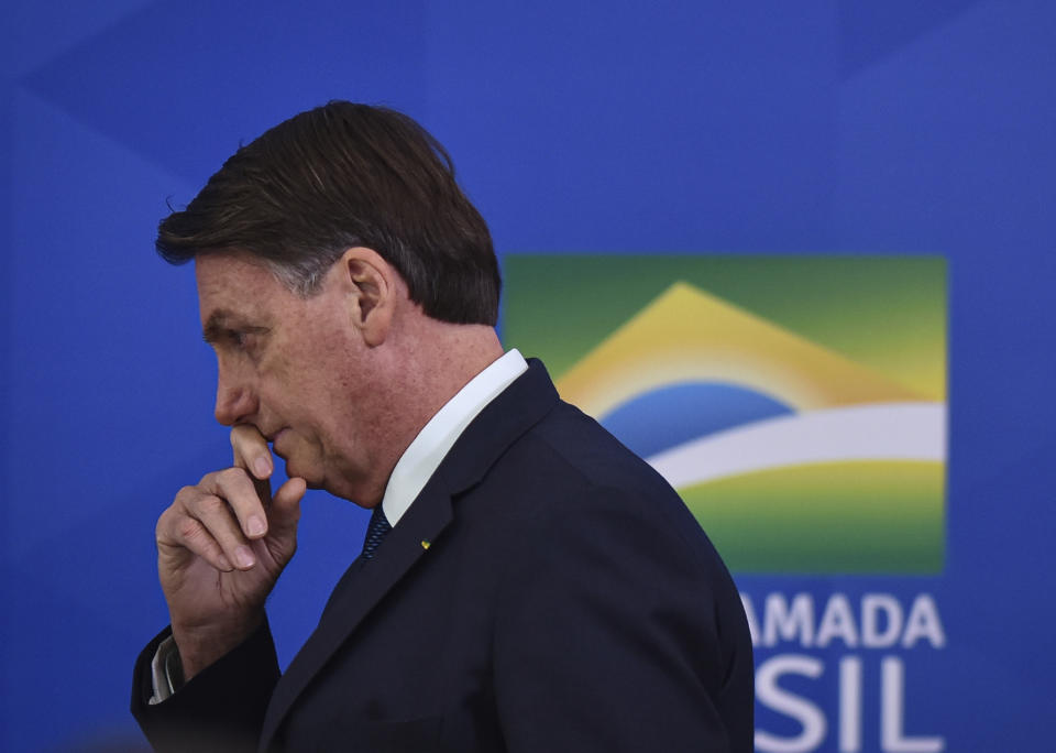 Brazil's President Jair Bolsonaro attends the swearing-in ceremony for his new Health Minister Nelson Teich at Planalto palace in Brasilia, Brazil, Friday, April 17, 2020. (AP Photo/Andre Borges)