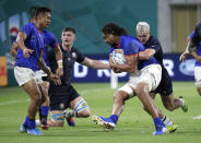 Scotland's Darcy Graham, right, tackles Samoa's Chris Vui during the Rugby World Cup Pool A game at Kobe Misaki Stadium between Scotland and Samoa in Kobe City, Japan, Monday, Sept. 30, 2019. (AP Photo/Aaron Favila)