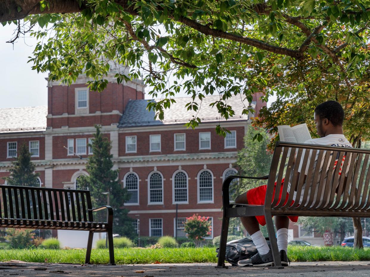 A young man reads on the Howard University campus July 6, 2021, in Washington.