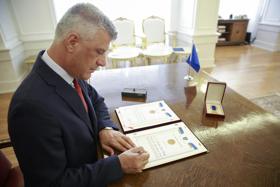 Kosovo's President Hashim Thaci signs the Order of Freedom awarded to U.S President Donald Trump, in capital Pristina, Kosovo on Friday, Sept. 18, 2020. Kosovo's president awarded U.S. President Donald Trump with one of the country's highest medals - Kosovo's Order of Freedom - for his government's efforts on peace and reconciliation in the former war-torn region. (AP Photo/Visar Kryeziu)