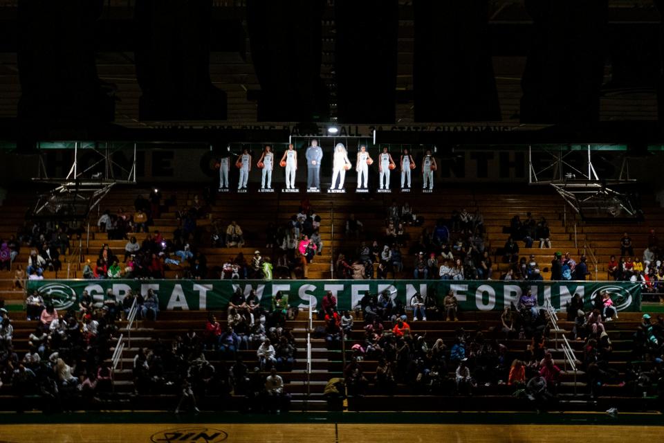 The 2021-22 state championship-winning Washington girls basketball team cutouts hang from the rafters before the Washington vs. Riley girls basketball game Tuesday, Nov. 15, 2022 at Washington High School.