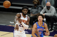Phoenix Suns center Deandre Ayton passes as Oklahoma City Thunder forward Isaiah Roby, right, defends during the second half of an NBA basketball game, Wednesday, Jan. 27, 2021, in Phoenix. (AP Photo/Matt York)