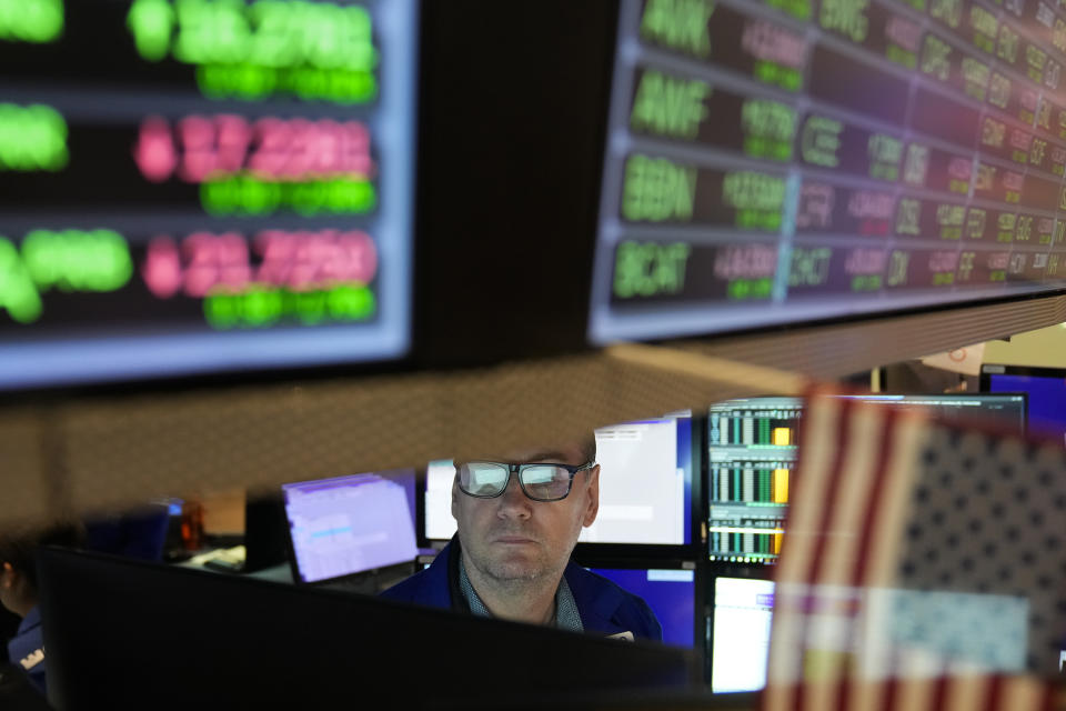 FILE - A traders works on the floor at the New York Stock Exchange in New York, Nov. 10, 2022. A section of the $1.7 trillion spending bill passed Friday has been billed as a dramatic step toward shoring up retirement accounts of millions of U.S. workers. But the real windfall may go to a far more secure group: the financial services industry. (AP Photo/Seth Wenig, File)