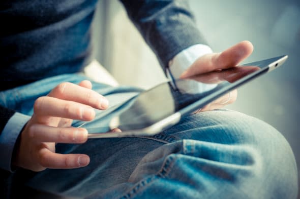 close up hands multitasking man using tablet, laptop and cellphone connecting wifi