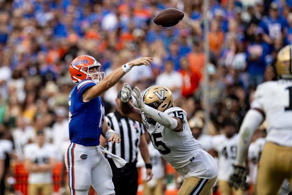 Florida Gators quarterback Graham Mertz (15) throws under pressure from Vanderbilt Commodores defensive end Nate Clifton (15) during the first half at Steve Spurrier Field at Ben Hill Griffin Stadium in Gainesville, FL on Saturday, October 7, 2023. [Matt Pendleton/Gainesville Sun]