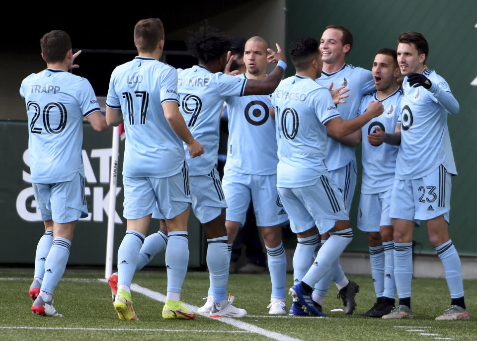 Minnesota United players celebrate a goal by midfielder Franco Fragapane during the first half of an MLS soccer match against the Portland Timbers in Portland, Ore., Sunday, Nov. 21, 2021. (AP Photo/Steve Dykes)