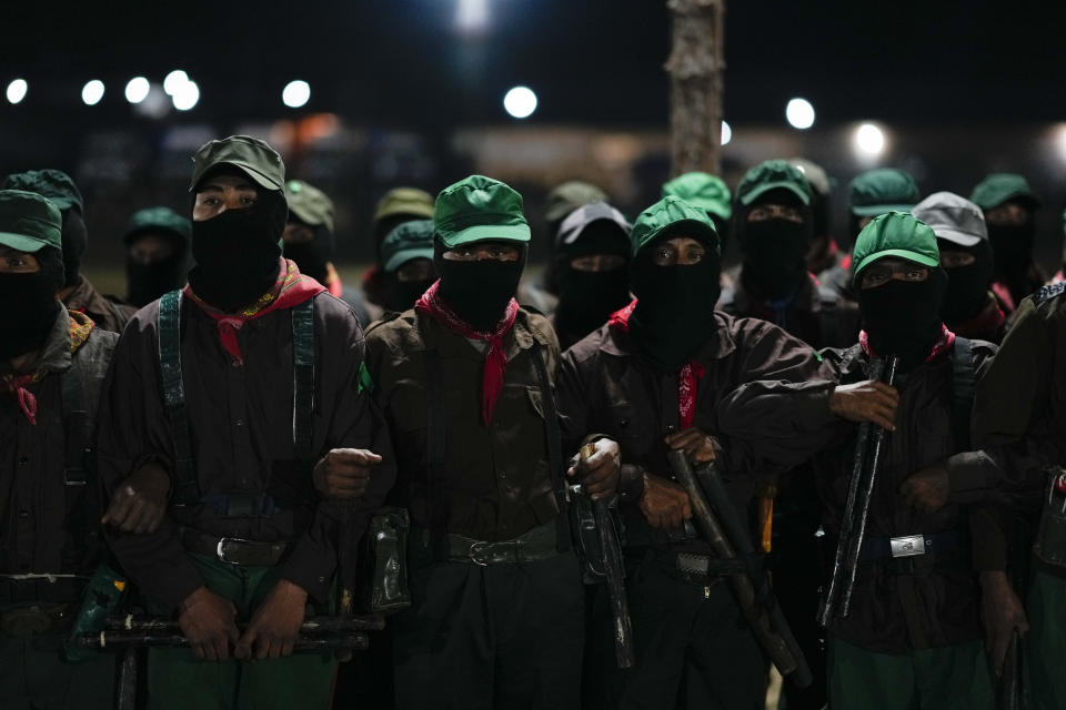 Members of the Zapatista National Liberation Army, EZLN, attend an event marking the 30th anniversary of the Zapatista uprising in Dolores Hidalgo, Chiapas, Mexico, Sunday, Dec. 31, 2023. (AP Photo/Eduardo Verdugo)