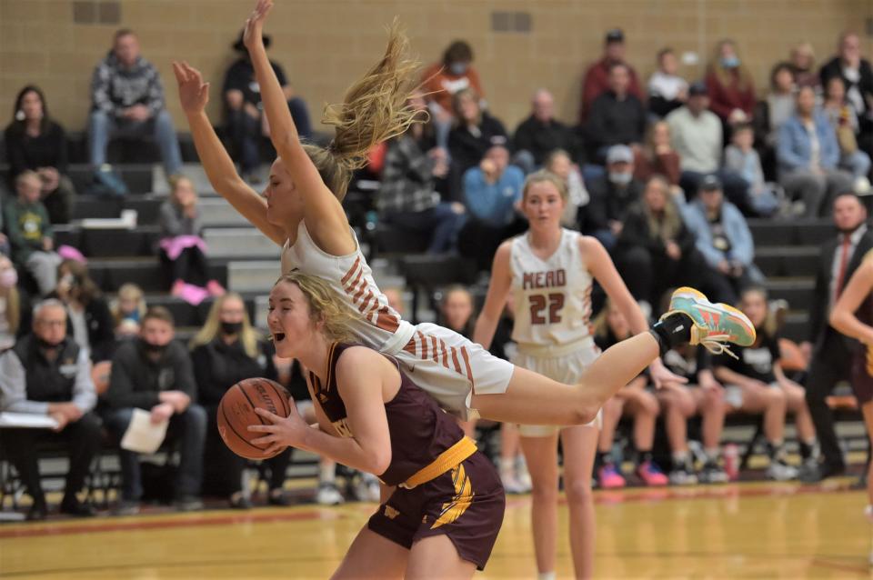 Windsor High School girls basketball player Lexi Backhaus is fouled by a Mead player during a game Friday, Jan. 28, 2022, in Longmont, Colo.