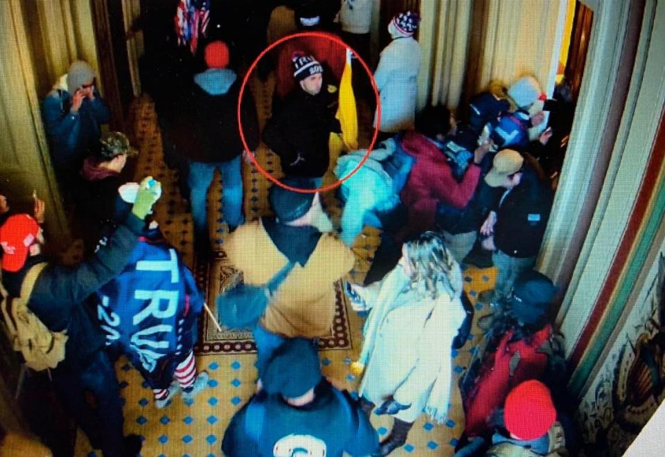 A man the FBI says is Mark Roger Rebegila of St. Marys, Kansas, is shown (inside the red circle) on U.S. Capitol closed-circuit television roaming through the building on Jan. 6.